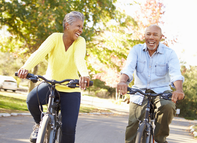 couple riding their bikes after hemorroid treatment and relief